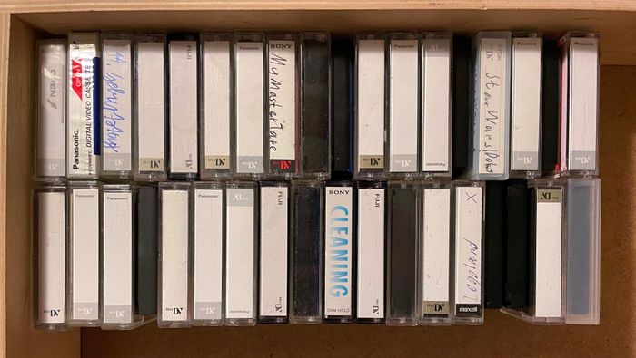 Box of old MiniDV cassettes